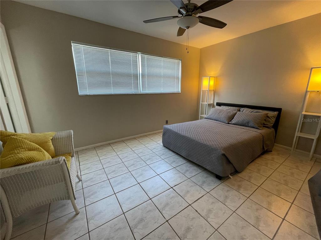 1433 South Belcher Road, Unit C1 Clearwater, FL 33764 - Photo 6 of 27 a bedroom with a bed and window