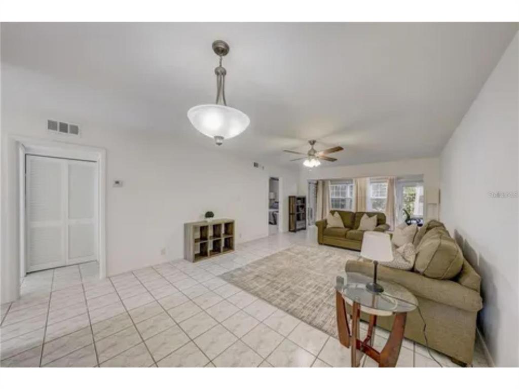 1433 South Belcher Road, Unit C1 Clearwater, FL 33764 - Photo 8 of 27 a living room with furniture and a chandelier