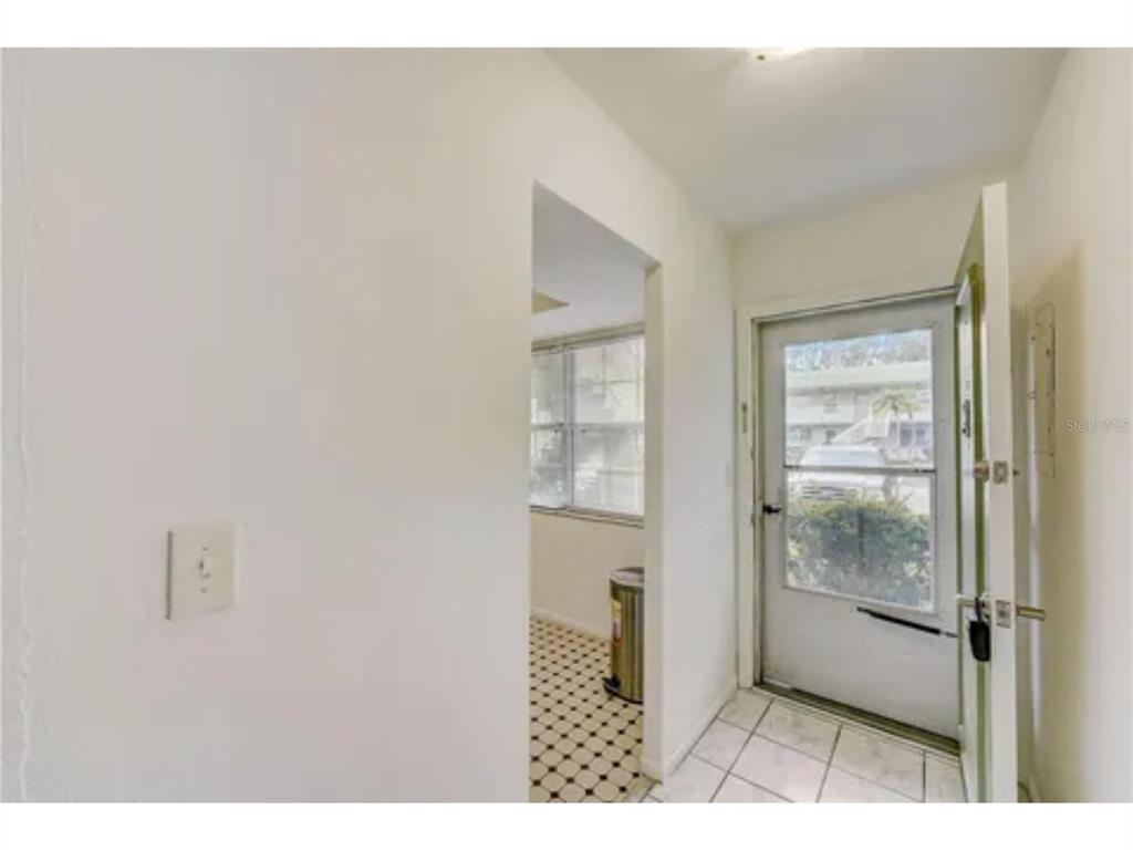1433 South Belcher Road, Unit C1 Clearwater, FL 33764 - Photo 10 of 27 a bathroom with a glass shower door