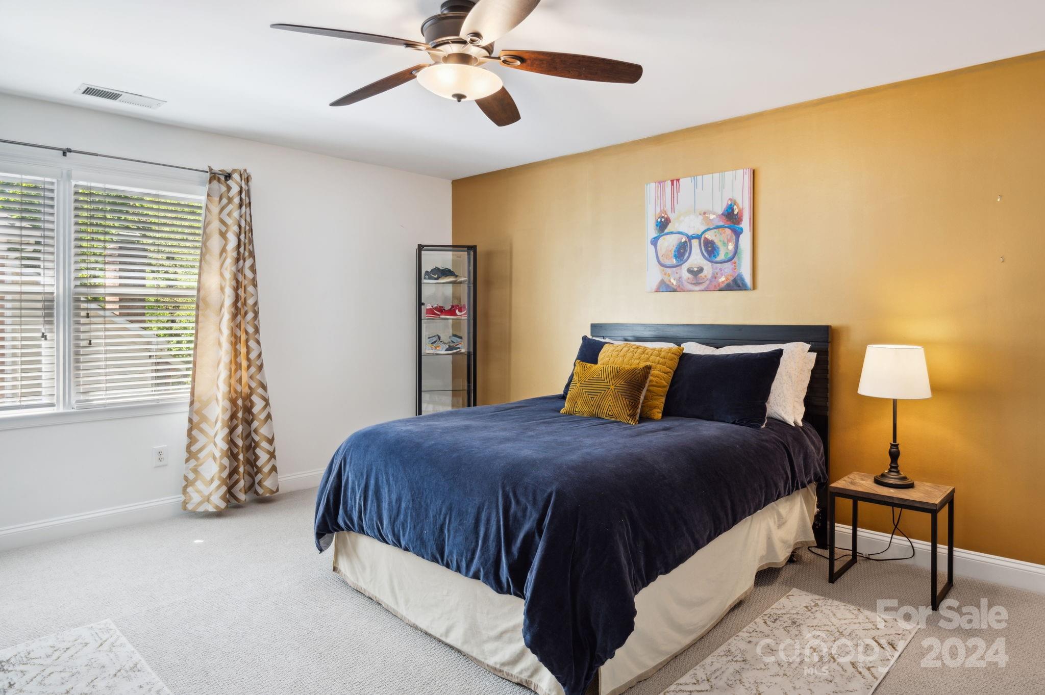 1418 Reverdy Oaks Drive Matthews, NC 28105 - Photo 33 of 45 a bedroom with a bed and a chandelier