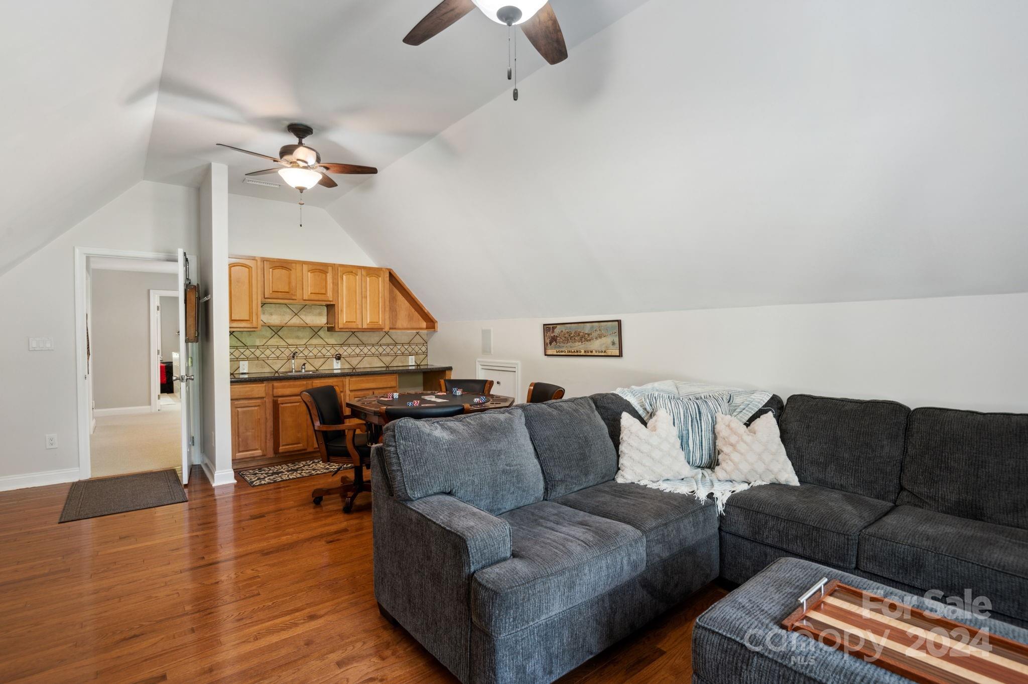 1418 Reverdy Oaks Drive Matthews, NC 28105 - Photo 36 of 45 a living room with furniture a fireplace and wooden floor