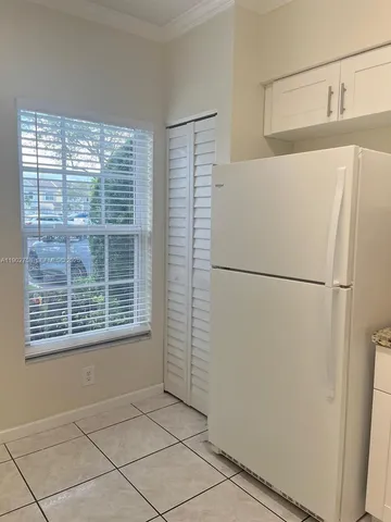 a view of a refrigerator in a kitchen