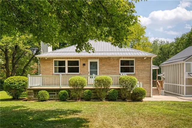 a front view of a house with a garden and yard