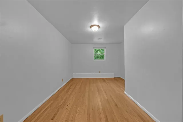 a view of a room with wooden floor and window
