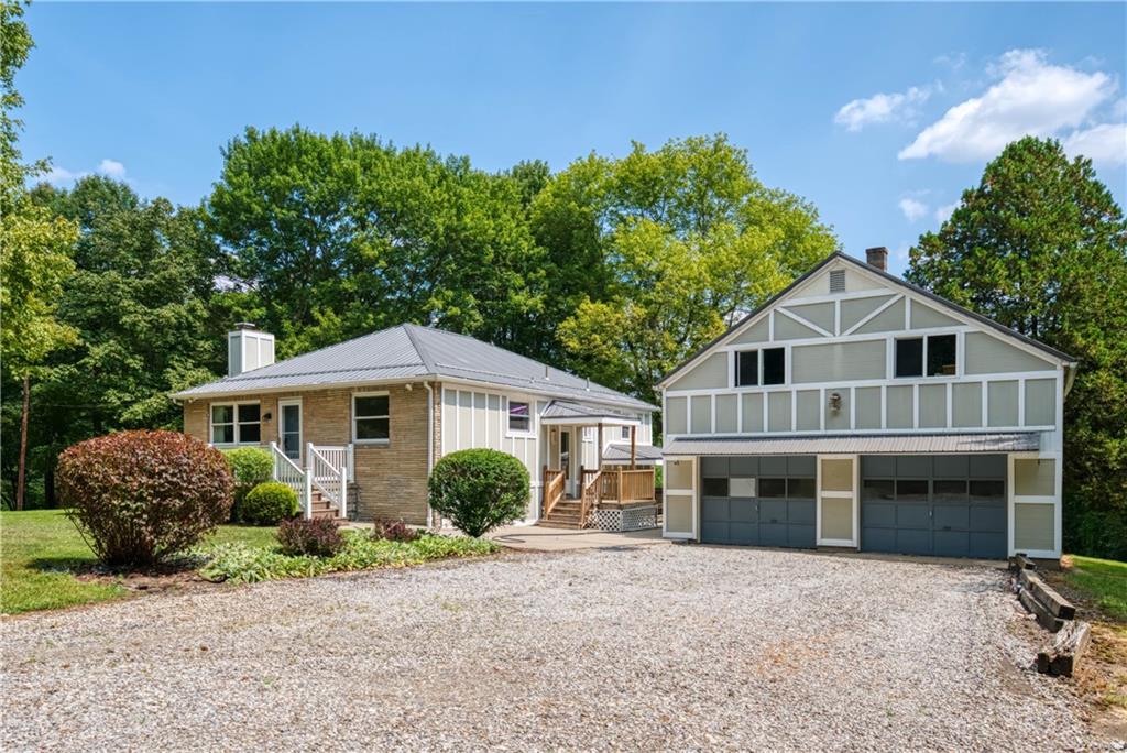 492 Center Grange Road Monaca, PA 15061 - Photo 2 of 36 a front view of a house with a garden