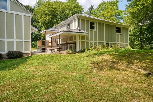 a view of a house with a yard and sitting area