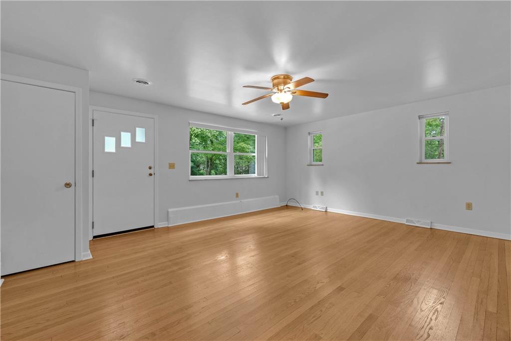 492 Center Grange Road Monaca, PA 15061 - Photo 9 of 36 a view of an empty room with a window and wooden floor