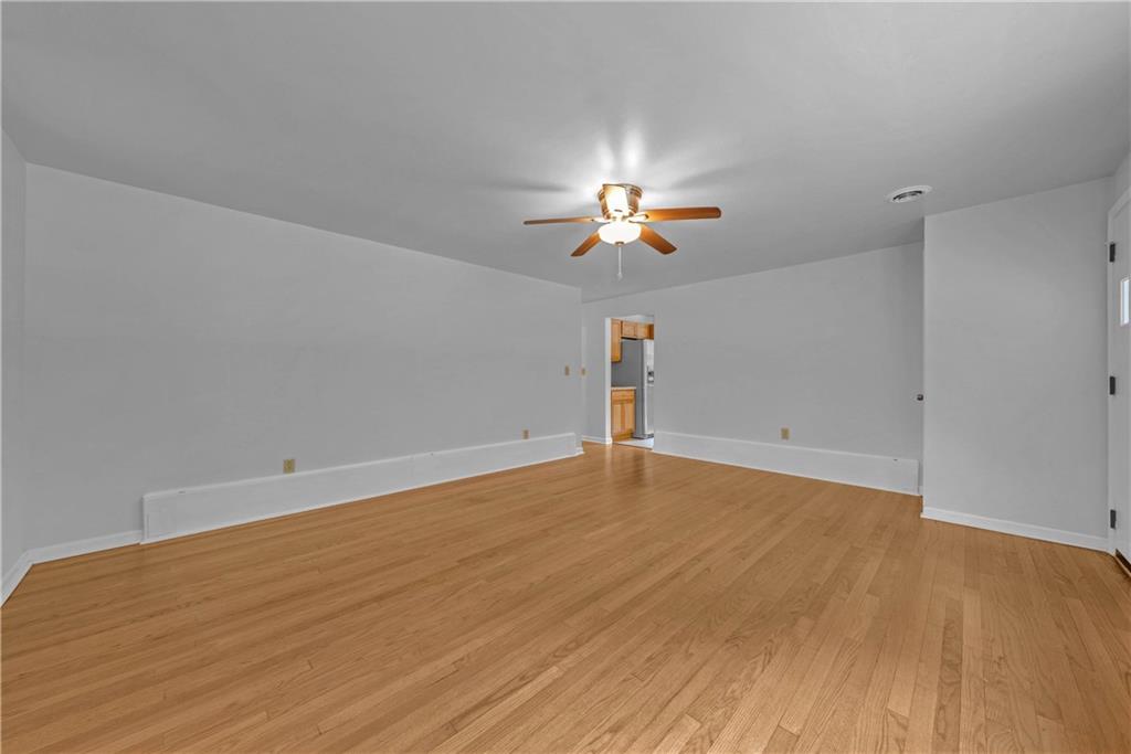 492 Center Grange Road Monaca, PA 15061 - Photo 10 of 36 wooden floor in an empty room with a chandelier fan