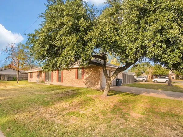 a view of a yard with a house and large trees