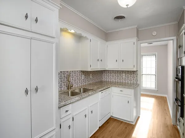 a kitchen with sink cabinets and window
