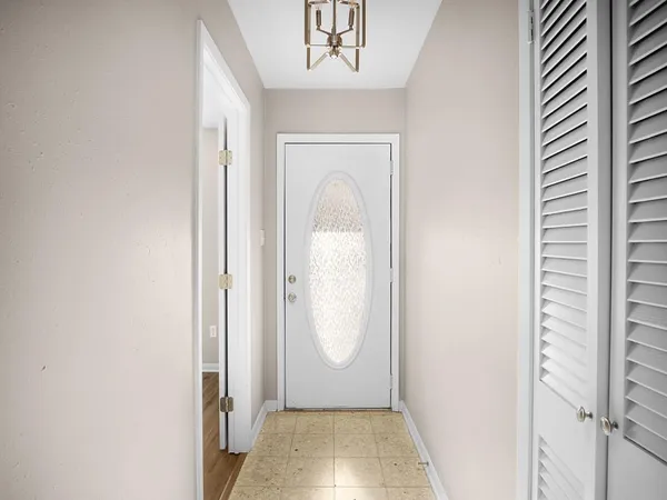 an empty room with wooden floor and a window