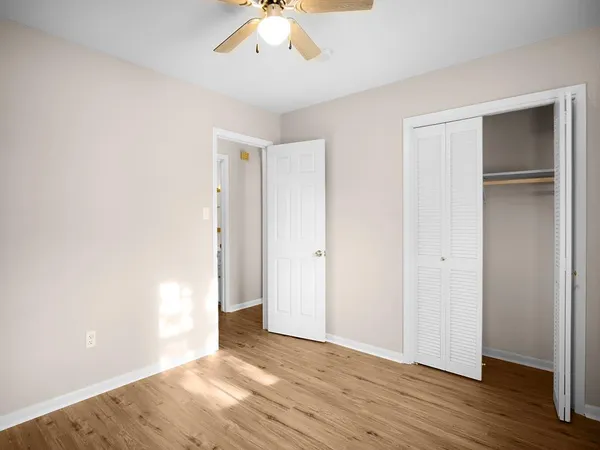 a view of an empty room with wooden floor