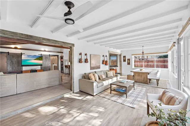 a living room with furniture and large windows