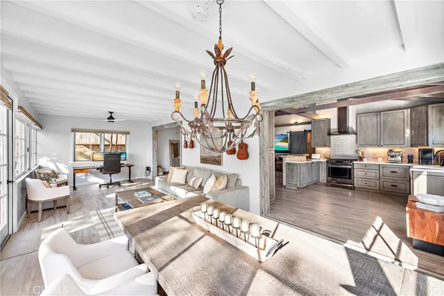 a bedroom with a bed a couch and a potted plant on the dresser