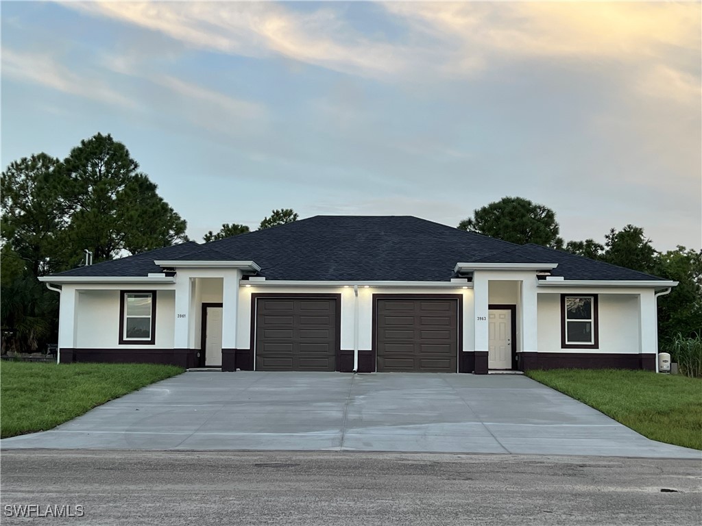3961-3963 Sunset Road Lehigh Acres, FL 33971 - Photo 1 of 18 front view of a house with a yard