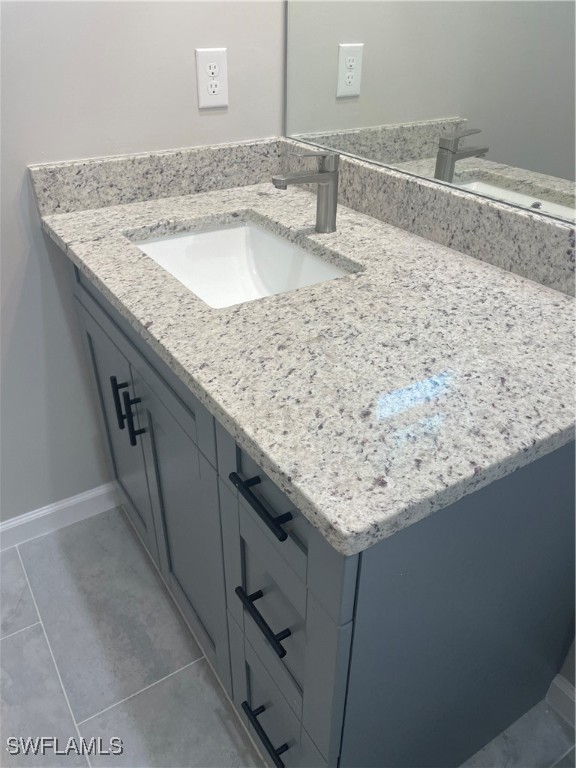 3961-3963 Sunset Road Lehigh Acres, FL 33971 - Photo 14 of 18 a bathroom with a granite countertop sink and a mirror