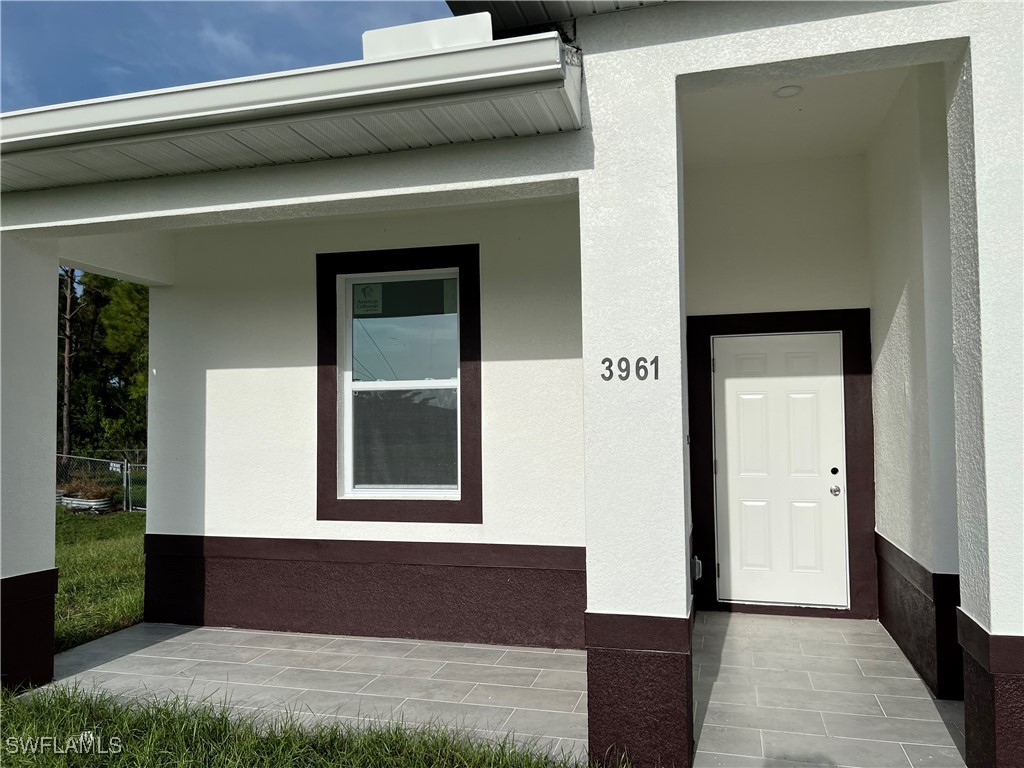 3961-3963 Sunset Road Lehigh Acres, FL 33971 - Photo 2 of 18 a front view of a house with a garage
