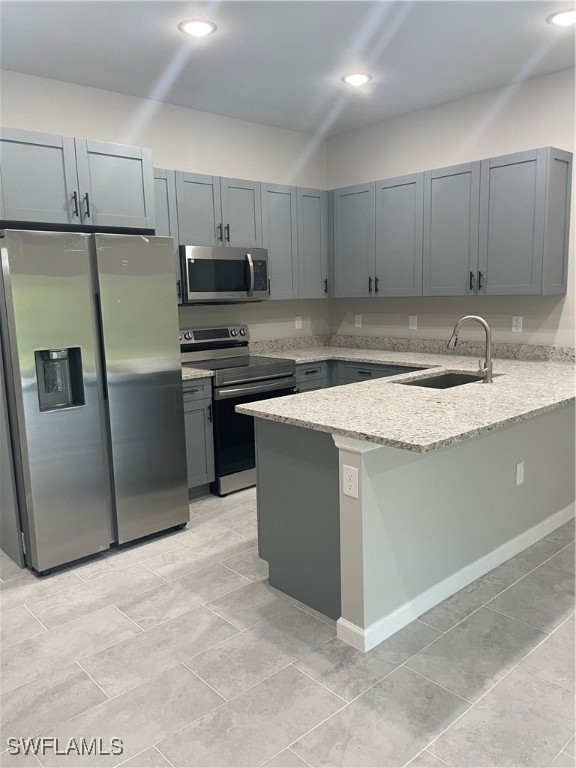 3961-3963 Sunset Road Lehigh Acres, FL 33971 - Photo 3 of 18 a kitchen with stainless steel appliances granite countertop a stove a sink and a refrigerator