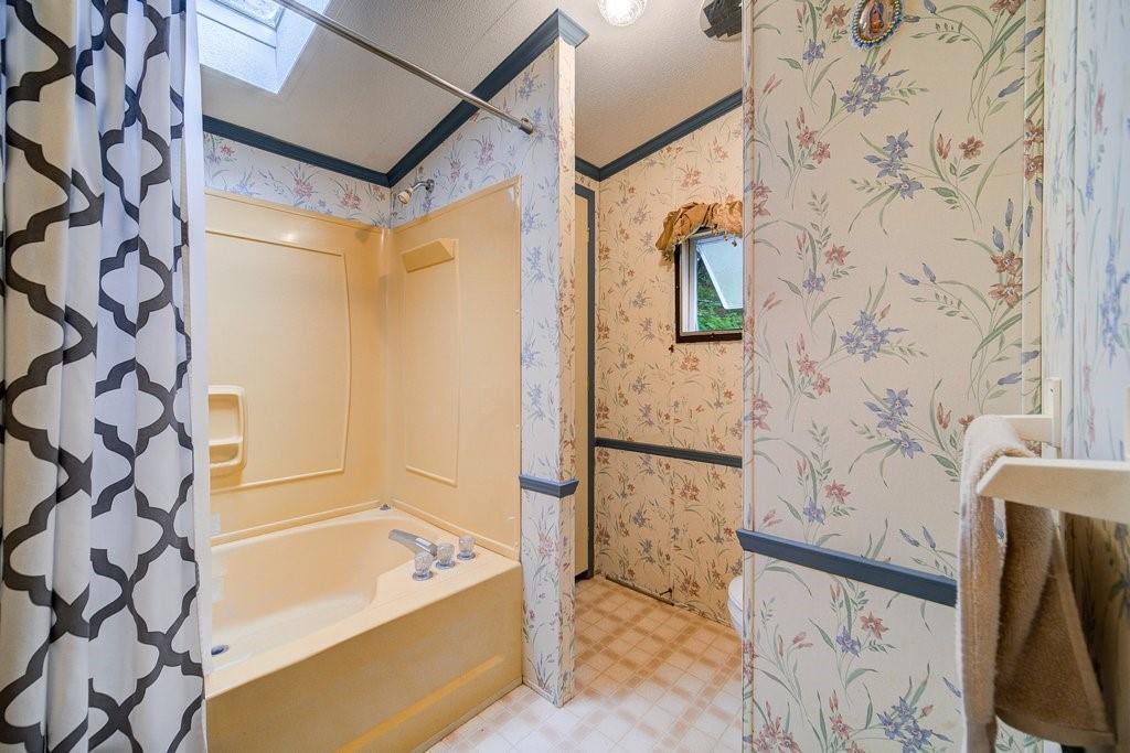 152 Old Tacy Road, Unit 95 Bethel, NY 12720 - Photo 11 of 16 a bathroom with a bathtub and shower