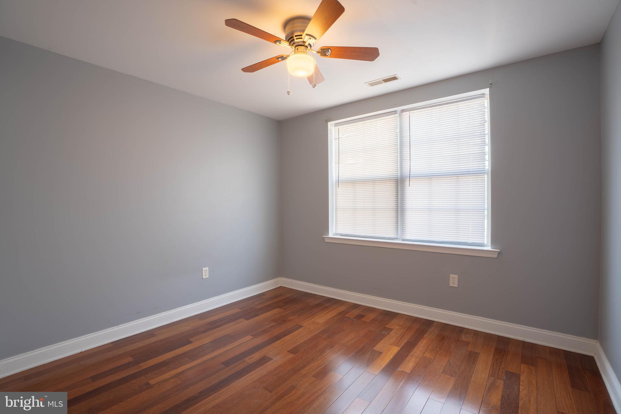 2212 North 16th Street, Unit 2 Philadelphia, PA 19132 - Photo 12 of 18 an empty room with wooden floor and windows