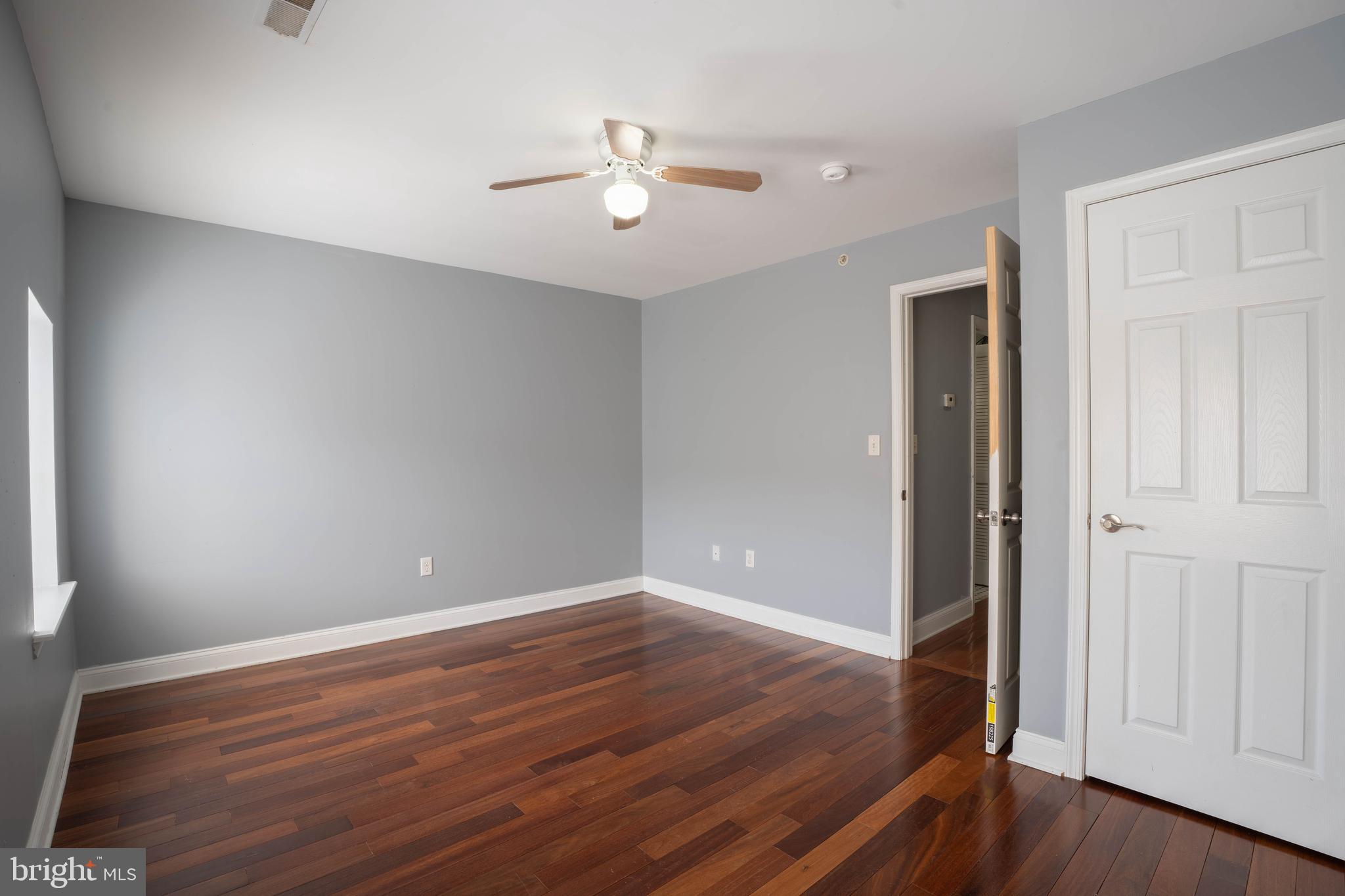 2212 North 16th Street, Unit 2 Philadelphia, PA 19132 - Photo 17 of 18 wooden floor in an empty room with a window