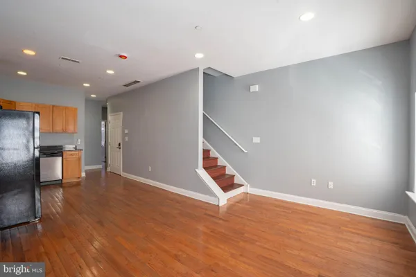 a view of empty room with wooden floor