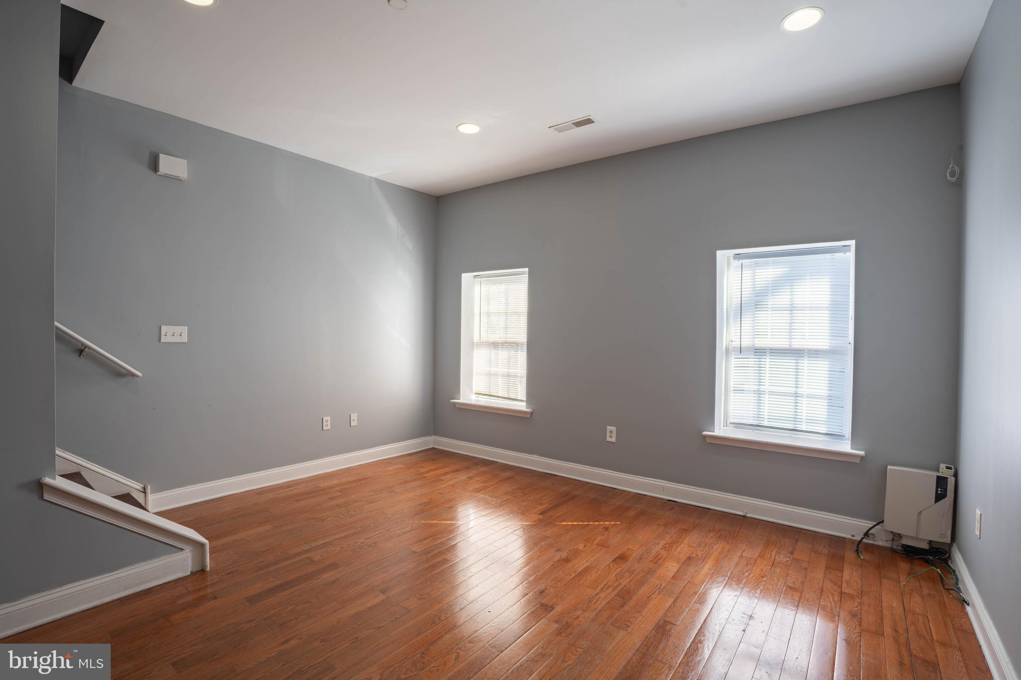 2212 North 16th Street, Unit 2 Philadelphia, PA 19132 - Photo 4 of 18 an empty room with wooden floor and windows