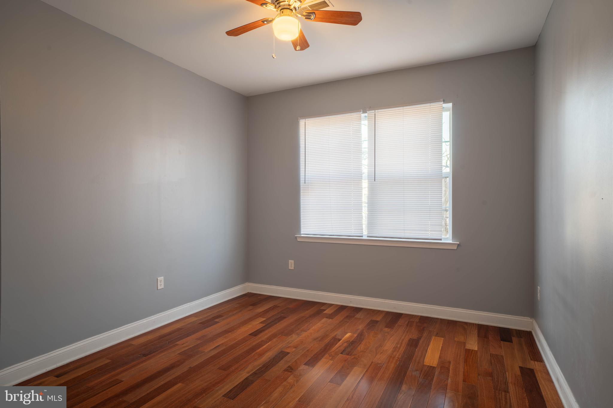 2212 North 16th Street, Unit 2 Philadelphia, PA 19132 - Photo 6 of 18 an empty room with a window and wooden floor