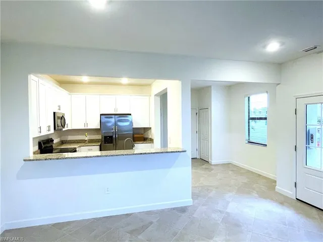 a view of a kitchen with kitchen island