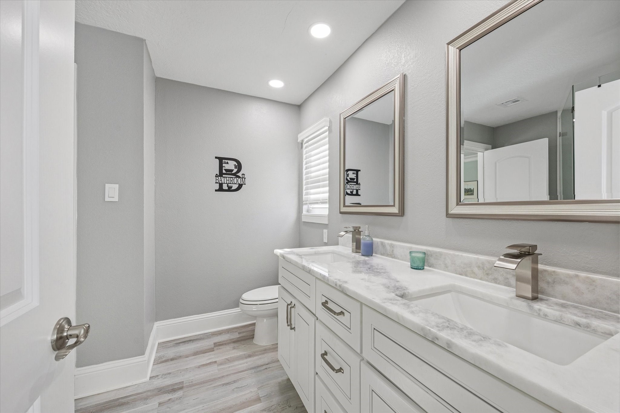 830 Silvergate Drive Houston, TX 77079 - Photo 28 of 38 a bathroom with a double vanity sink mirror and toilet