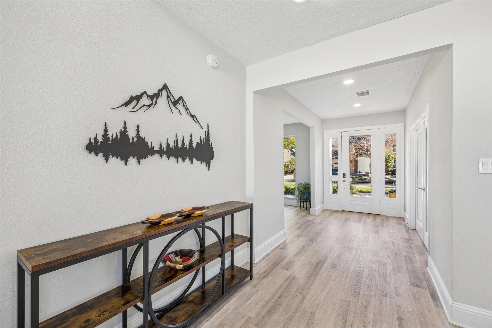830 Silvergate Drive Houston, TX 77079 - Photo 5 of 38 a view of a hallway with wooden floor and stairs