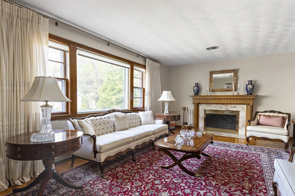 156 Woodcliff Road Newton, MA 02461 - Photo 4 of 17 a living room with furniture fireplace and a large window