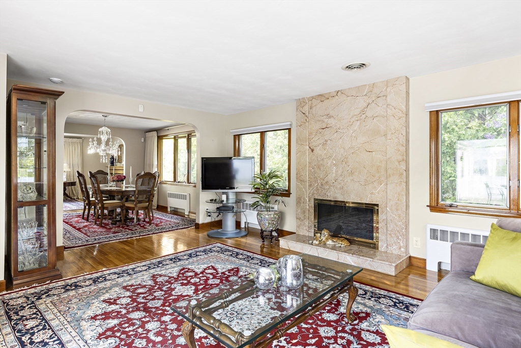156 Woodcliff Road Newton, MA 02461 - Photo 7 of 17 a living room with furniture a rug a fireplace and a flat screen tv
