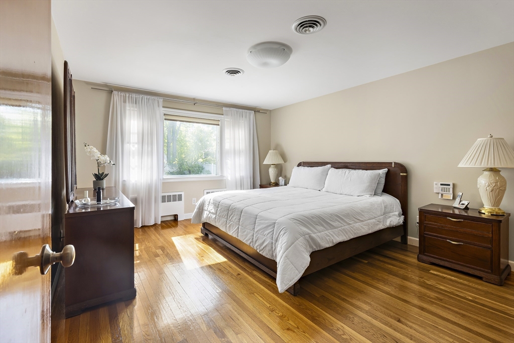 156 Woodcliff Road Newton, MA 02461 - Photo 8 of 17 a bedroom with a bed and wooden floor