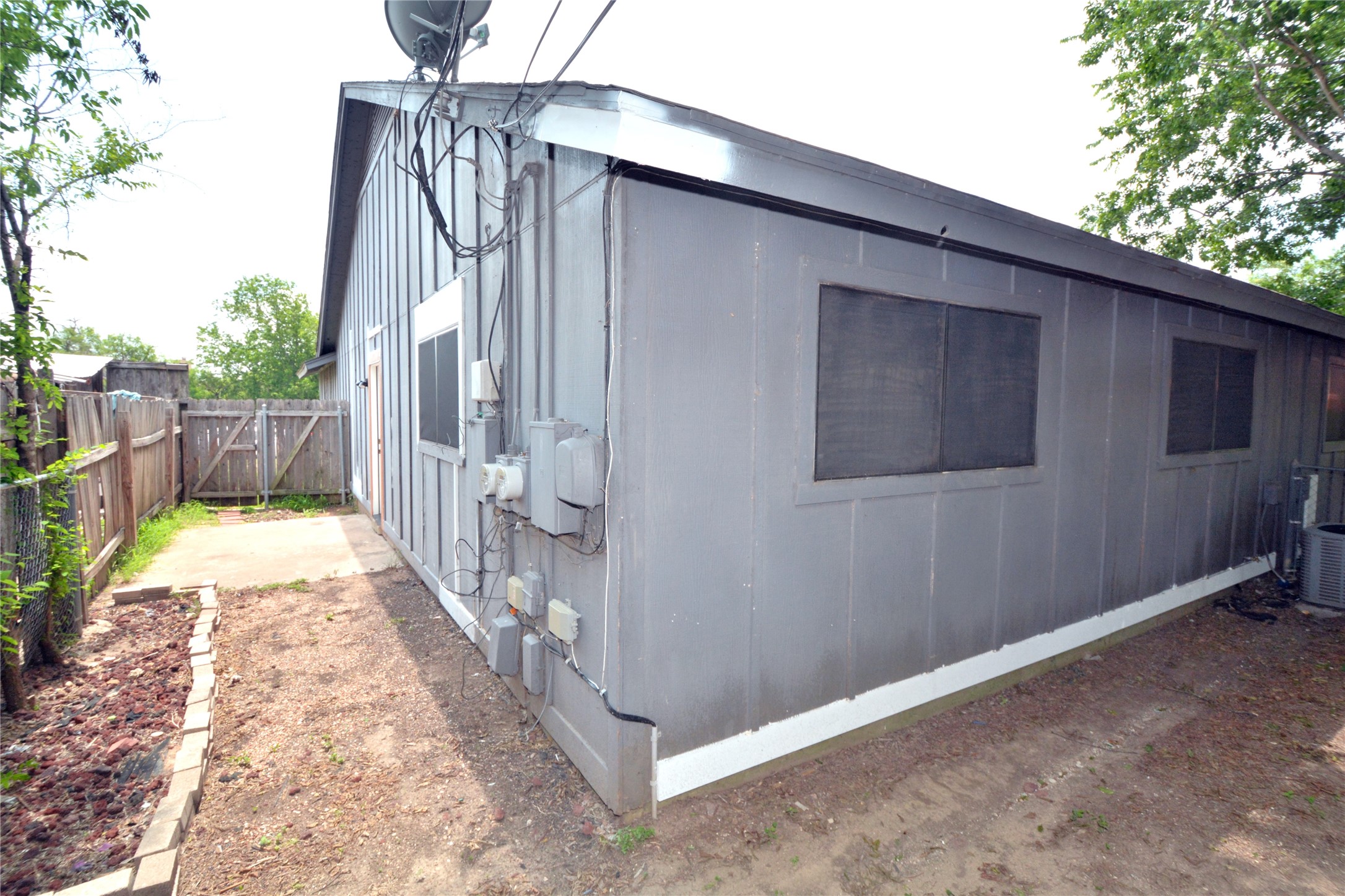 11314 Walnut Ridge Drive, Unit B Austin, TX 78753 - Photo 19 of 19 A robust wooden fence encloses the private yard, offering both security and outdoor space.