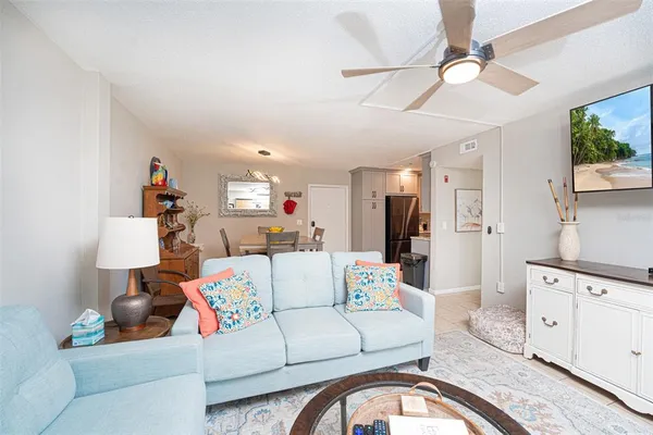a living room with furniture and a chandelier