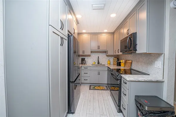 a kitchen with a refrigerator a sink and a stove