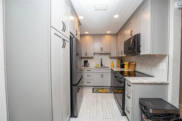a kitchen with a refrigerator a sink and a stove