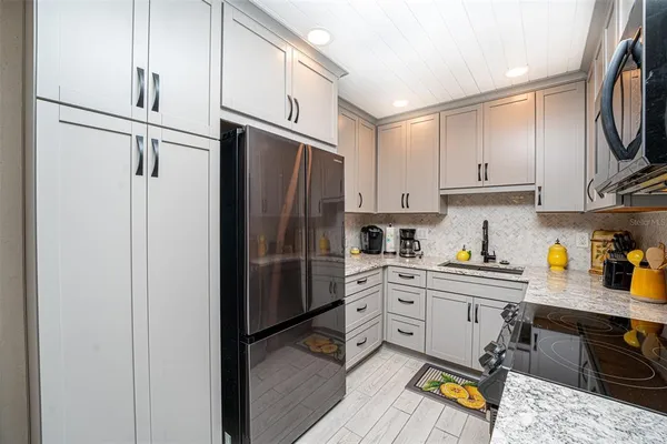 a kitchen with stainless steel appliances a refrigerator sink and cabinets