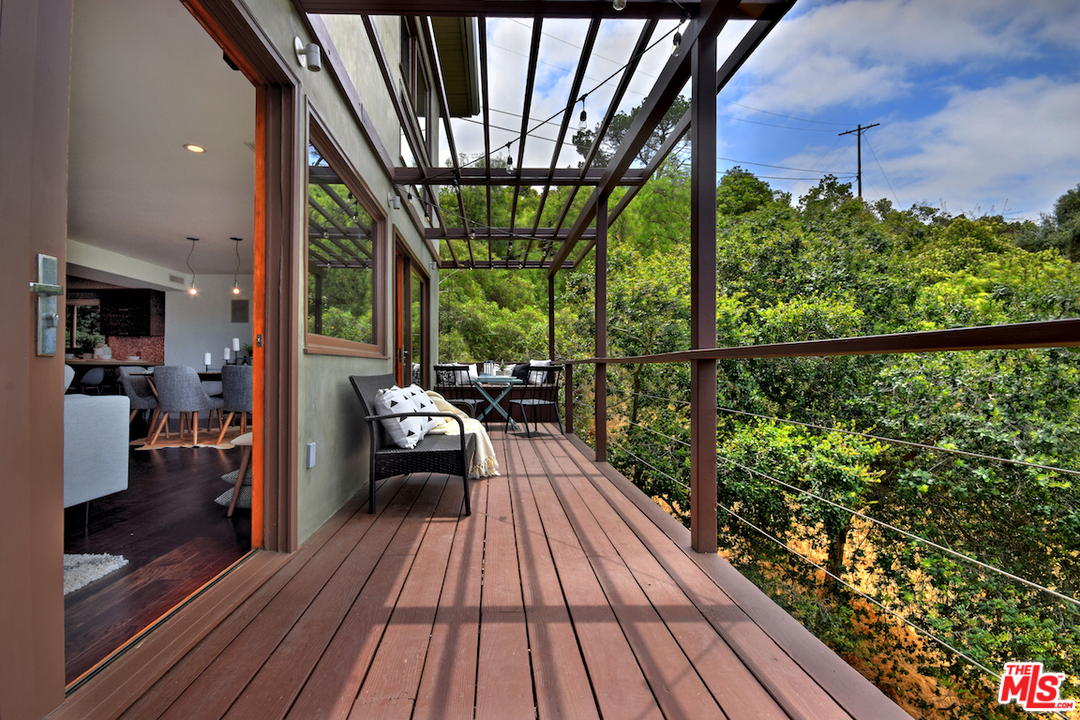 3605 Alta Mesa Drive Studio City, CA 91604 - Photo 22 of 47 a balcony with wooden floor and outdoor seating