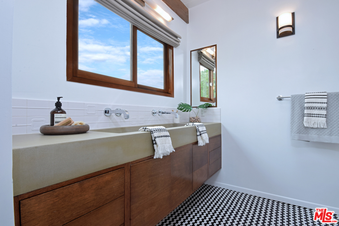 3605 Alta Mesa Drive Studio City, CA 91604 - Photo 42 of 47 a bathroom with a sink and a mirror