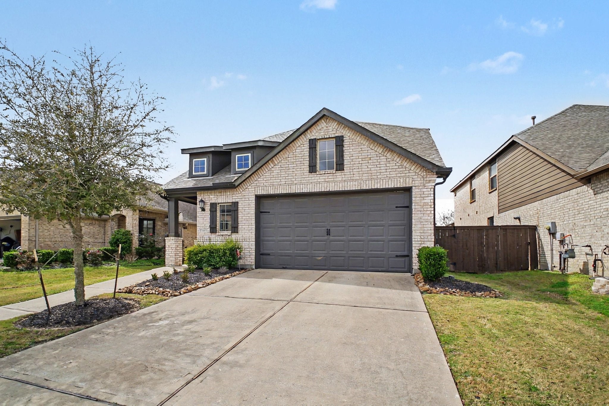 10602 Wagner Street Rosharon, TX 77583 - Photo 3 of 35 a front view of a house with a yard and garage
