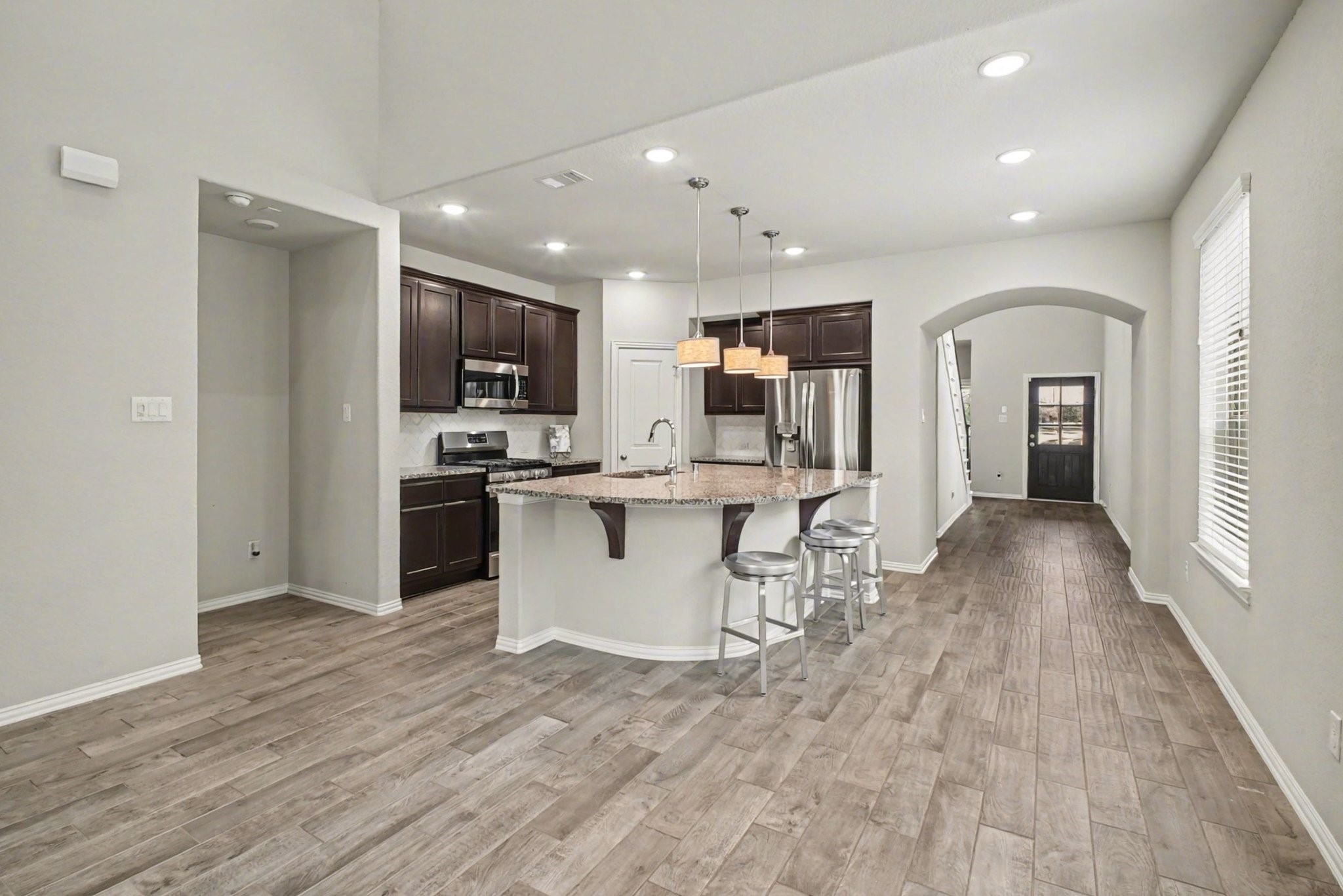 10602 Wagner Street Rosharon, TX 77583 - Photo 4 of 35 a view of a kitchen with kitchen island granite countertop a stove top oven a sink a counter space and cabinets