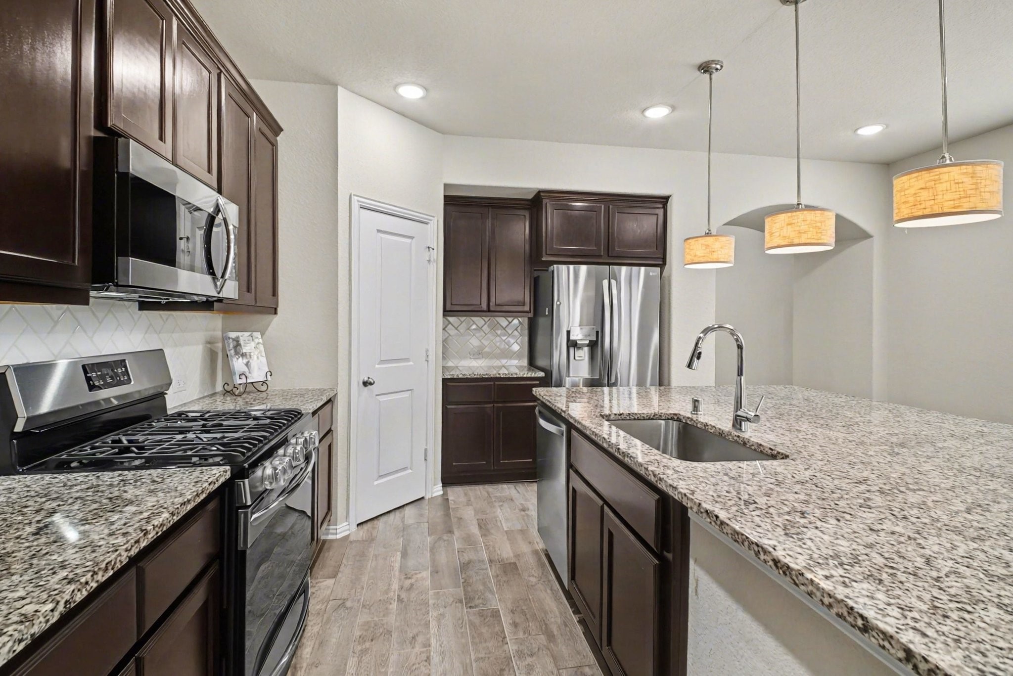 10602 Wagner Street Rosharon, TX 77583 - Photo 6 of 35 a kitchen with stainless steel appliances granite countertop a sink a stove and a refrigerator