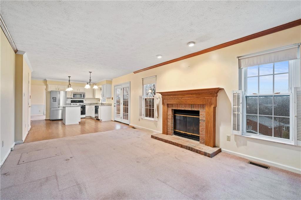 522 Leland Drive Pittsburgh, PA 15236 - Photo 11 of 22 a view of a livingroom with furniture a fireplace and windows
