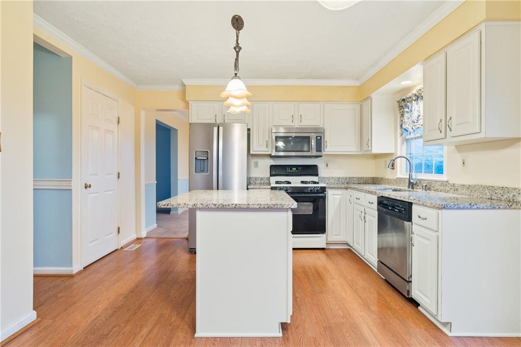 522 Leland Drive Pittsburgh, PA 15236 - Photo 9 of 22 a kitchen with a sink cabinets stainless steel appliances and a window