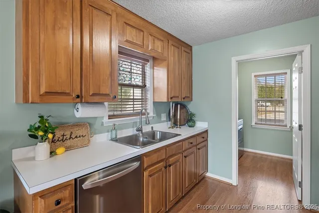 a kitchen with granite countertop a sink and a window