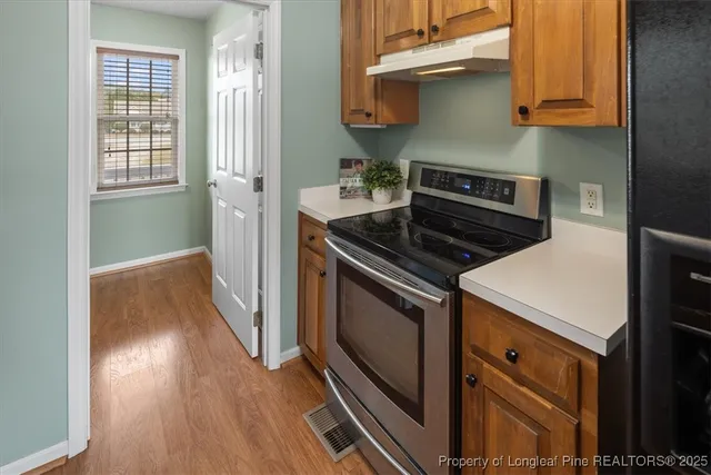 a kitchen with a refrigerator stove and cabinets