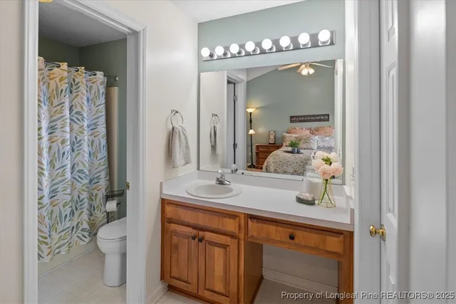 a bathroom with a toilet and a shower curtain
