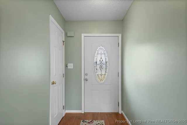 a living room with furniture a fireplace and a large window